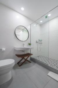 a bathroom with a toilet and a sink and a shower at Central Hotel Ridge in Accra