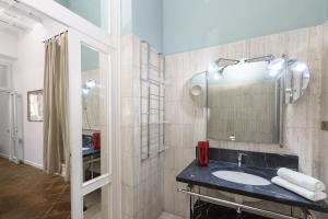 a bathroom with a sink and a mirror at Bernini al Borgo in Rome +16 photos