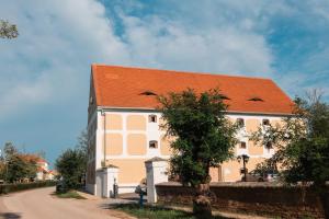 ein großes Gebäude mit orangefarbenem Dach an einer Straße in der Unterkunft Granarium in Ilok + 27 Fotos