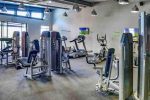 a gym with several treadmills and exercise bikes at 2Bed in exquisite golf estate! in Roodepoort