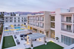 an aerial view of a building with a swimming pool at HOTEL PASEO, Autograph Collection in Palm Desert