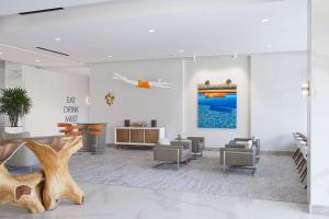a lobby with chairs and a table and a tree at HOTEL PASEO, Autograph Collection in Palm Desert +80 photos