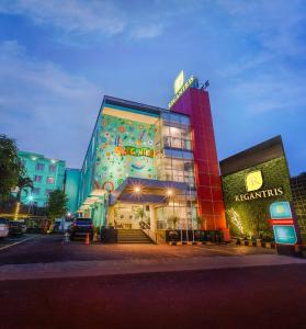 a building with a sign on the side of it at Regantris Malioboro in Yogyakarta