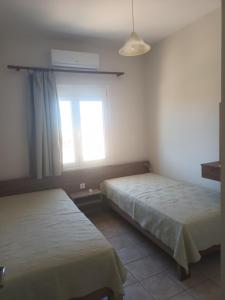 A bed or beds in a room at Cathrin Beach Apartments