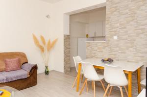 a kitchen and living room with a table and chairs at Apartment Relax in Stolac