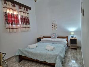 a bedroom with a bed with towels on it at ANiko in Kolymbia