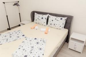 a bedroom with a bed with black and white comforter at Apartment Relax in Stolac