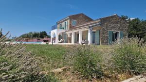 a house on a hill with plants in the foreground at Villa San Silvestro in Oprtalj