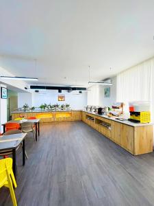 a large kitchen with tables and chairs in a cafeteria at Karvan Sanatorium Naftalan in Naftalan