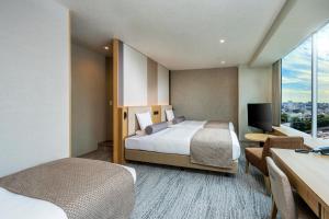 Postel nebo postele na pokoji v ubytování ART HOTEL Nippori Lungwood