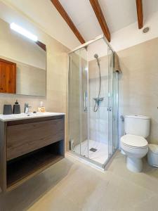 a bathroom with a shower and a toilet and a sink at Villa BONA VISTA in Son Bou