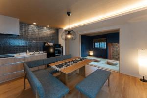 a kitchen with a table and two chairs and a counter at 下新町 庵 in Kanazawa