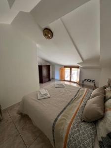 a bedroom with a large bed with two towels on it at Maison Camigliati in Camigliatello Silano +12 photos