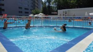 a group of people playing in a swimming pool at Arena Mar Hotel and SPA in Golden Sands