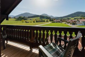 a bench on a deck with a view of a valley at Ferienwohnung Westernberg in Ruhpolding