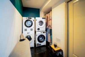 two washing machines sitting next to each other in a room at The Hammock Hotel Ben Thanh in Ho Chi Minh City
