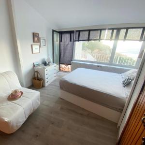 a bedroom with a bed and a large window at El 66 de Cap Sa Sal in Begur
