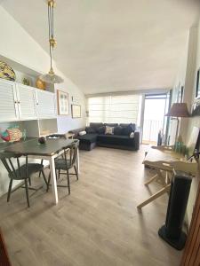 a living room with a couch and a table at El 66 de Cap Sa Sal in Begur