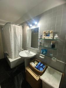 a bathroom with a sink and a mirror and a tub at El 66 de Cap Sa Sal in Begur
