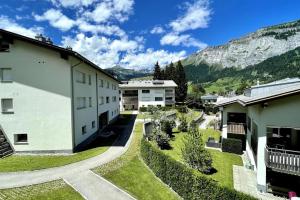 arial view of a building with mountains in the background at Private luxury 4 bedroom apartment in Flims Waldhaus in Flims