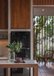 a kitchen with a table with a vase with a plant at The Garden Pavilion in Colombo