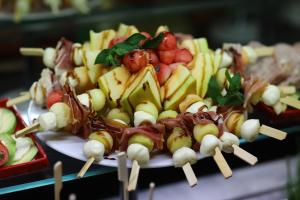 a plate of food with skewers of fruit and vegetables at Arena Mar Hotel and SPA in Golden Sands