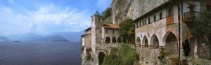 an old building next to a large body of water at Bella Italia chalet in Massino Visconti