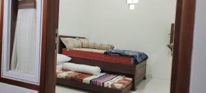 Postel nebo postele na pokoji v ubytování Harmony Resto&Homestay