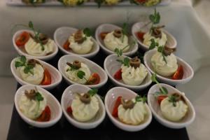 a bunch of dessert dishes in small cups on a table at Arena Mar Hotel and SPA in Golden Sands