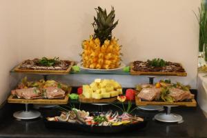 a buffet of different types of food on plates at Arena Mar Hotel and SPA in Golden Sands