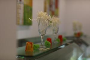 two wine glasses with food in them on a counter at Arena Mar Hotel and SPA in Golden Sands