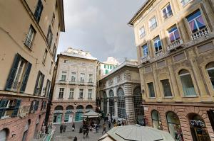 a group of buildings in a street with an umbrella at Genova Porto Antico Boutique Rooms in Genova
