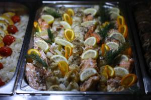 a tray of different types of food with oranges andmons at Arena Mar Hotel and SPA in Golden Sands