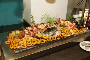 a buffet of different types of food on a table at Arena Mar Hotel and SPA in Golden Sands