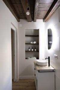 a white bathroom with a sink and a mirror at Casa Nicola in Toro +37 photos