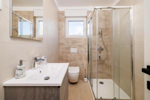 a bathroom with a sink and a shower at Schmidt mali in Dramalj +16 photos
