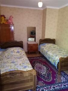 Postel nebo postele na pokoji v ubytování Tskaltubo Guesthouse Oda