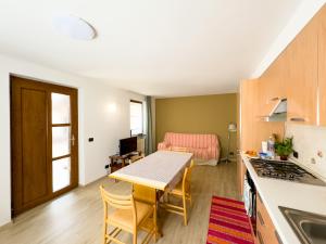 a kitchen with a table and a dining room at Belvedere Hotel in Crodo
