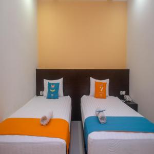 Uma cama ou camas num quarto em Sans Hotel Nagari Malioboro