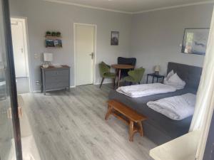 a living room with a bed and a table at 4-Bett-Appartement am Golfplatz in Grassau