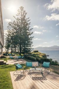 a group of chairs sitting on a deck near the water at Sofitel Golfe d'Ajaccio Thalassa Sea & Spa in Ajaccio