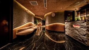 a waiting room with brown leather chairs and a table at Hanoi Lion Boutique Hotel & Spa in Hanoi +59 photos