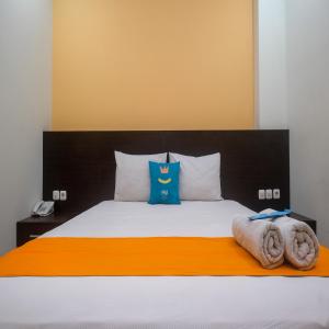 Uma cama ou camas num quarto em Sans Hotel Nagari Malioboro
