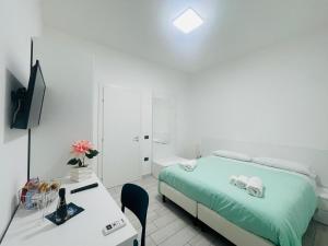 a bedroom with a bed and a desk and a television at Villa ilary in Casa Toscano