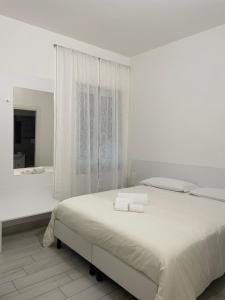 a white bedroom with a bed and a bath tub at Villa ilary in Casa Toscano +12 photos