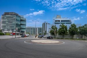 an empty street in a city with buildings at Cozy Suite Rogoredo Apartment next to the metro and train station in Milan