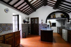 a kitchen with an island in the middle of a room at Quinta dos Afectos in São Vicente Ferreira