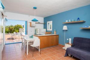 a kitchen and a living room with a couch and a table at Elea Villas Steni Vala Alonissos in Steni Vala Alonissos