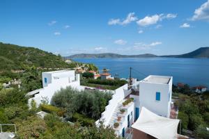 a view of a house with a view of the water at Elea Villas Steni Vala Alonissos in Steni Vala Alonissos
