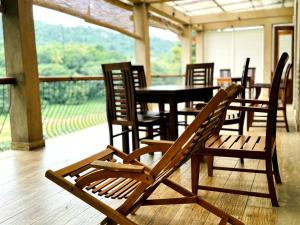 a group of chairs and a table in a restaurant at Rivorich Residence Kandy in Kandy